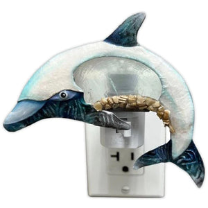 Blue Dolphin Metal and Capiz Night Light plugged into wall outlet