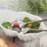 Mudpie Stoneware Conch Shell Salad Bowl with salad greens and serving utensils