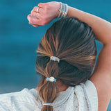 Model wearing K'lani "Wonder" Wrist and Hair Tie Bracelets Set in her hair and on her wrist