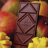 Manoa "Manako Mango" Chocolate Bar, 2.1-Ounce displayed with mango fruit