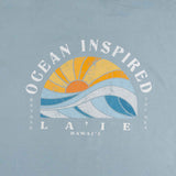 Closeup of large sun and waves graphic with text on the shirt's back.