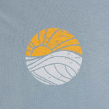 Closeup of the Sun and Waves graphic on the shirt's front over the left breast pocket.