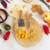 Totally Bamboo Pineapple-shaped Cutting Board with cheese chunks and crackers and surrounded by various other food items.