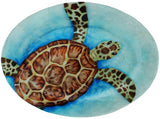 Blue Oval plate with sea turtle design on top of it