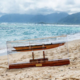 Hand-carved Samoan Canoe with Acrylic Display Case on a beach