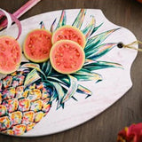 Home Essentials Oblong Ceramic Pineapple Trivet with sliced fruit.