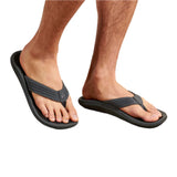 Model wearing Olukai "Ulele" Men's  Sandals-Dark Shadow/Black