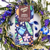 Hawaiian Host "Surfer's Breakfast" Dark Chocolate Bar surrounded by flower wreath