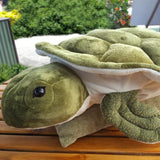 ImagWishpets Giant Honu (Sea Turtle) Plush on an outdoor table